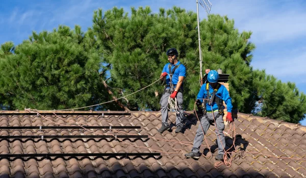 two-men-installing-solar-panels-on-a-house-2026-03-16-05-05-31-utc