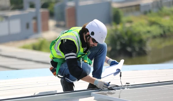 workers-installing-solar-panels-on-warehouse-roof-2026-01-07-07-27-35-utc
